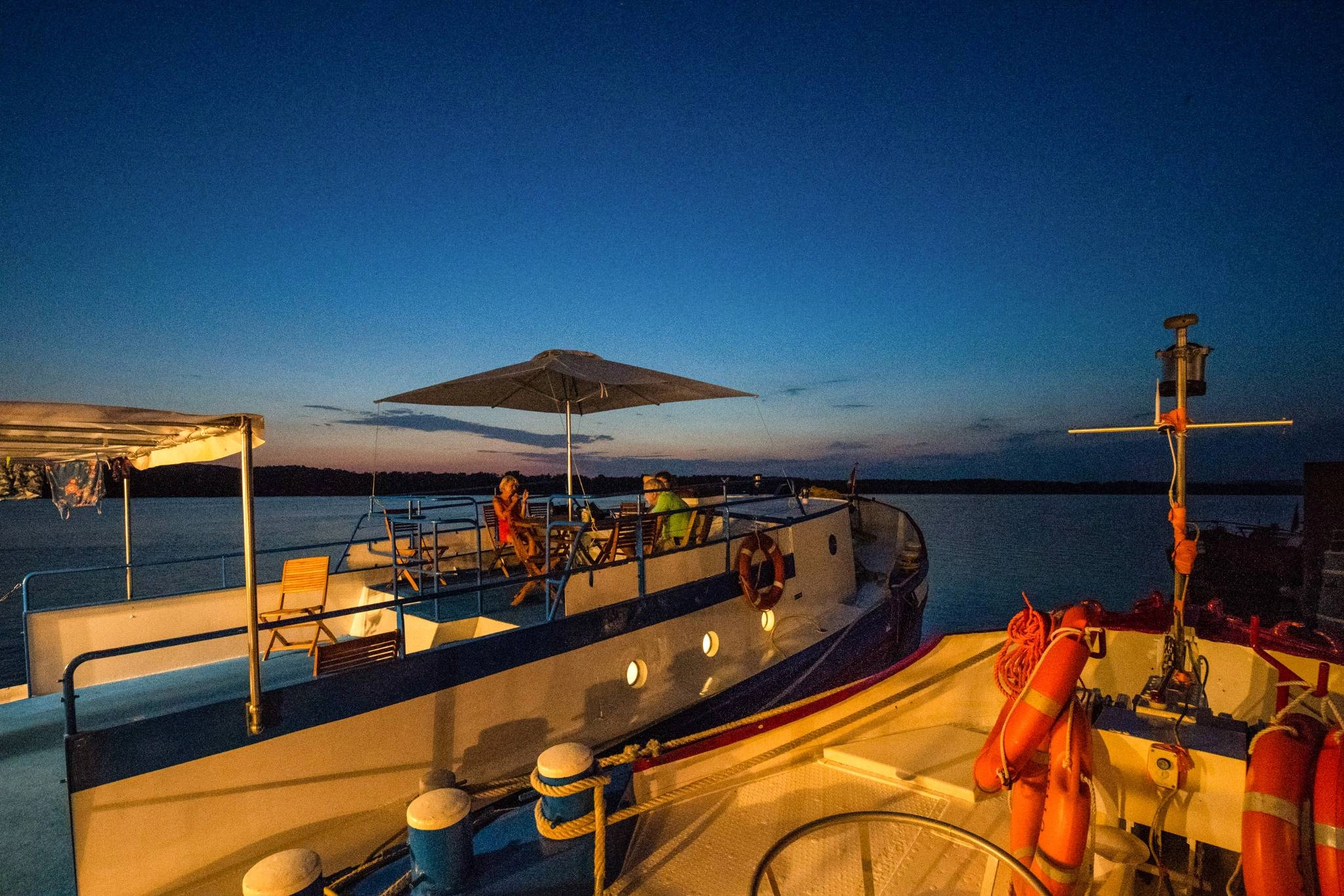 Evening view of the cruise ship Caprice with guests on deck at sunset in the Camargue